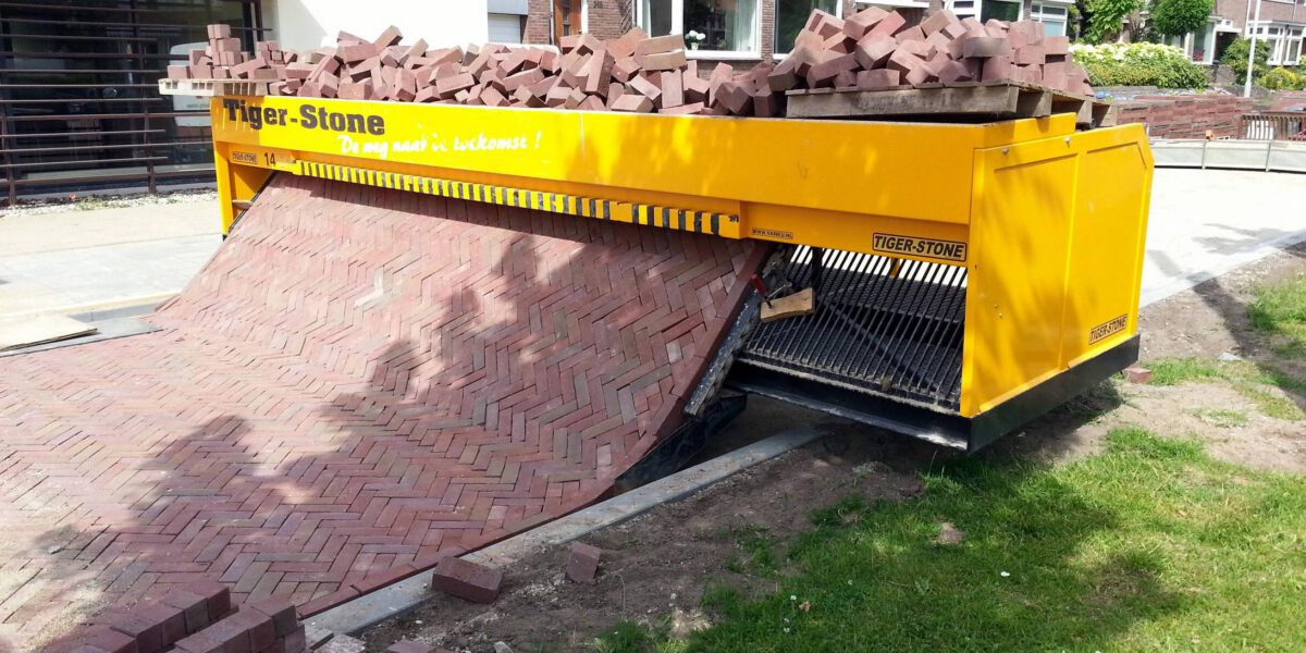 follow-the-self-made-road-incredible-machine-that-lays-out-a-carpet-of-bricks-removing-back-breaking-hard-work