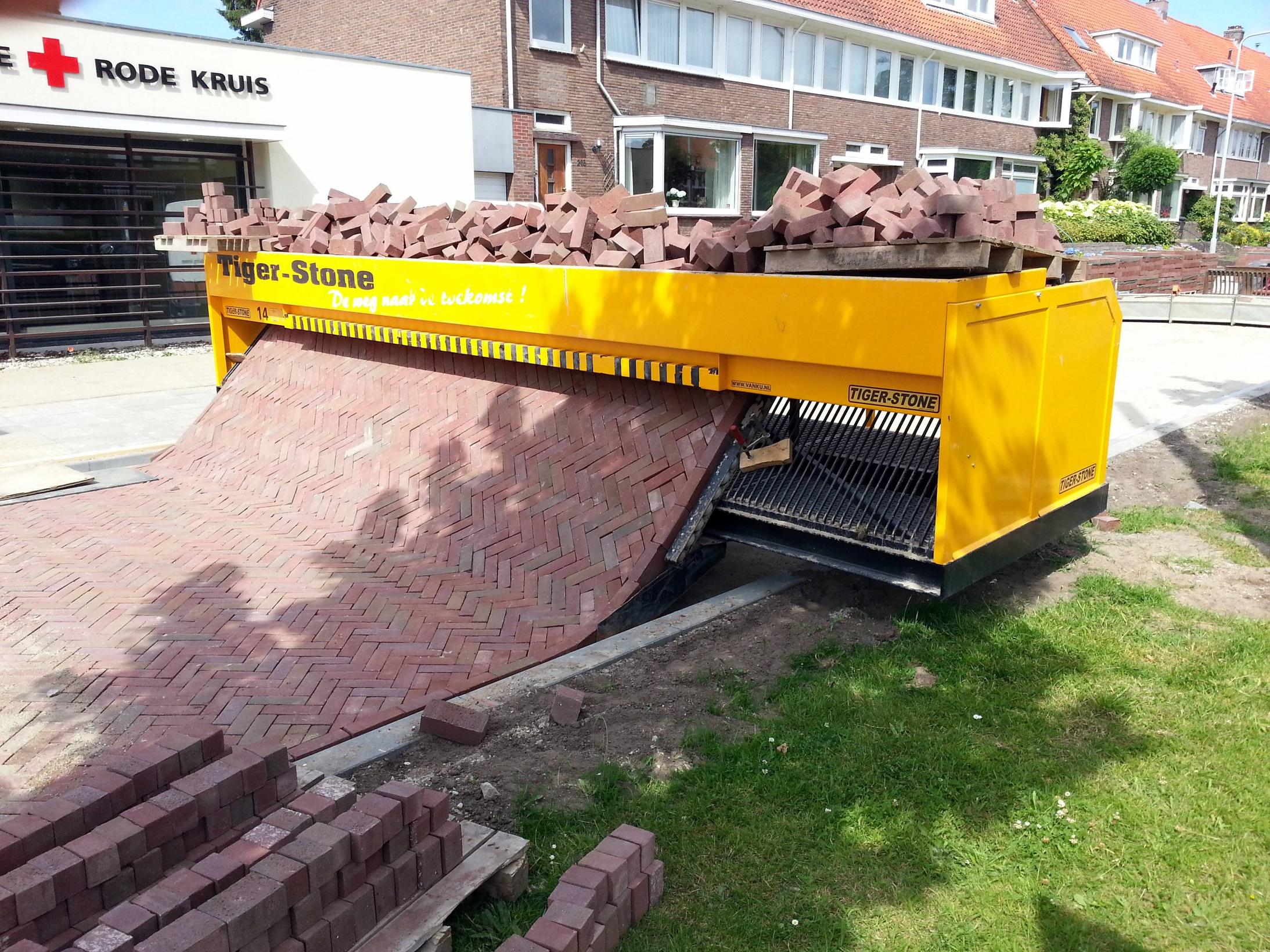 Follow the self-made road: Incredible machine that lays out a carpet of bricks removing back-breaking hard work