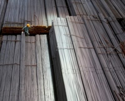 A man climbs on steel packages at Hoa Phat steel mill in Hai Duong Province, Vietnam. Photo by Reuters/Kham.
