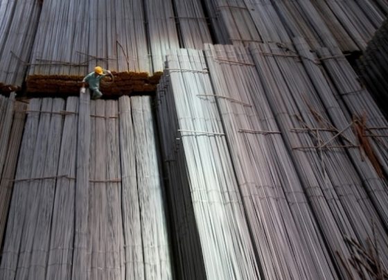 A man climbs on steel packages at Hoa Phat steel mill in Hai Duong Province, Vietnam. Photo by Reuters/Kham.